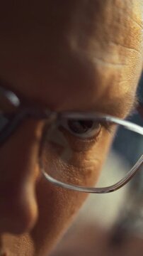 An artisan focuses on meticulous work in a brightly lit studio, embodying traditional craftsmanship and artistic manufacturing processes through careful hand movements with tools