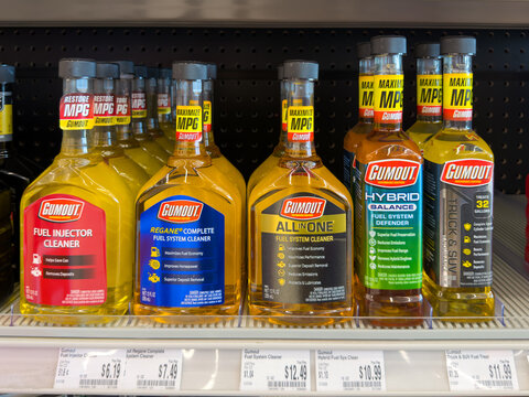 Aubrey, Texas, USA - September 22nd, 2026: Yellow Gumout fuel injector cleaner and system defender bottles inside AutoZone store