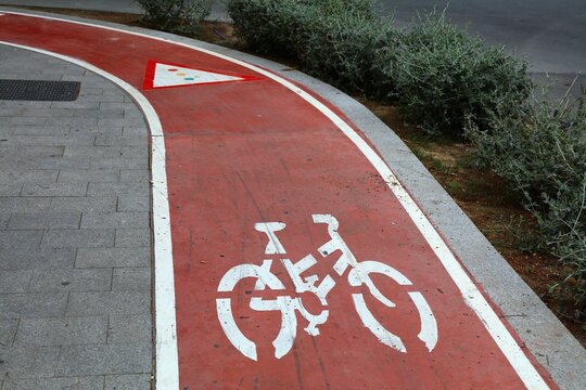 Alicante city bicycle path with traffic light warning sign. Urban street in Benidorm town in Valencian Community (Comunidad Valenciana), Spain.