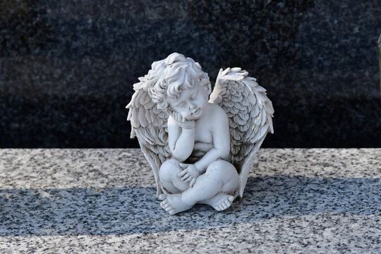 sweet dreaming angel figure on a grave