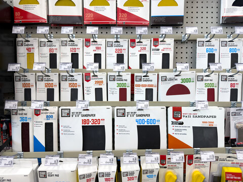 Aubrey, Texas, USA - September 22nd, 2026: Sure Bilt sandpaper sheets hanging on pegboard shelves inside AutoZone retail store