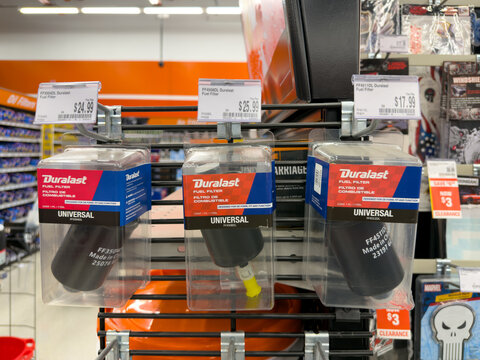 Aubrey, Texas, USA - September 22nd, 2026: Duralast fuel filter boxes hanging on metal display rack inside AutoZone retail store