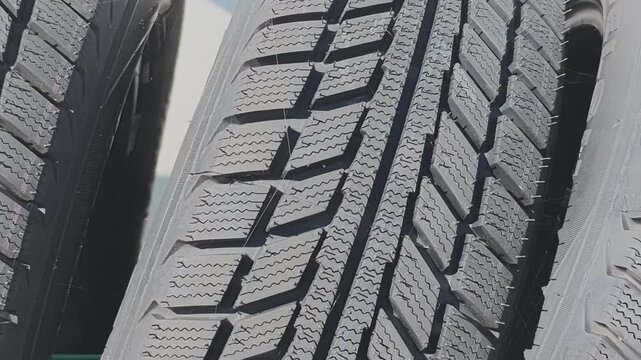 Detailed close up of a new set of winter tires. The black rubber tread pattern provides traction and safety on snow and icy roads