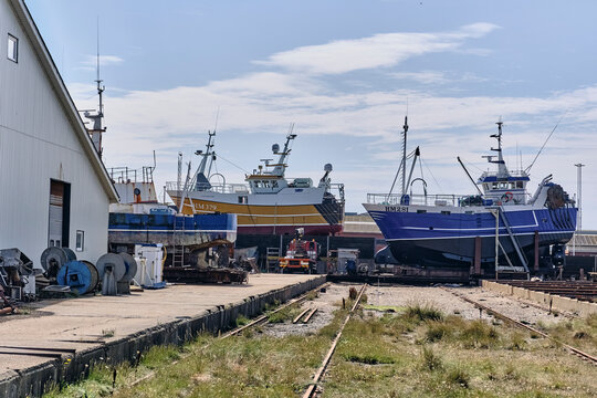 Fishing ships on the docks for repair in Hanstholm, Denmark, maritime industry and vessel maintenance at a shipyard with boats hauled out for service