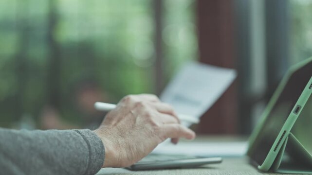 Planning finance requires careful analysis, so planning investment portfolio combines market analysis before finalizing project planning details on digital tablet.