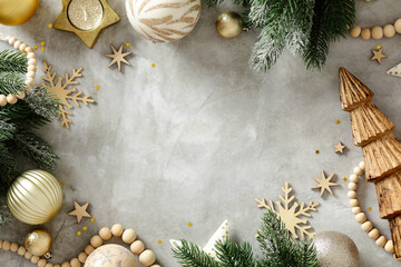 Fototapeta premium Scandinavian Christmas flat lay with golden decorations and pine branches