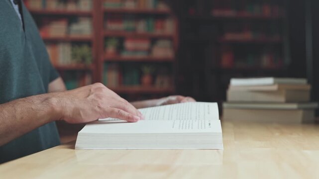 Reader engaged in study turns pages, practicing study habits as dedicated study fosters academic research across library books.