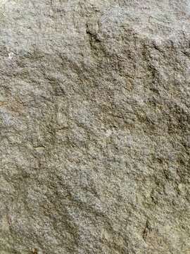 High angle close up view of rough grey stone texture background