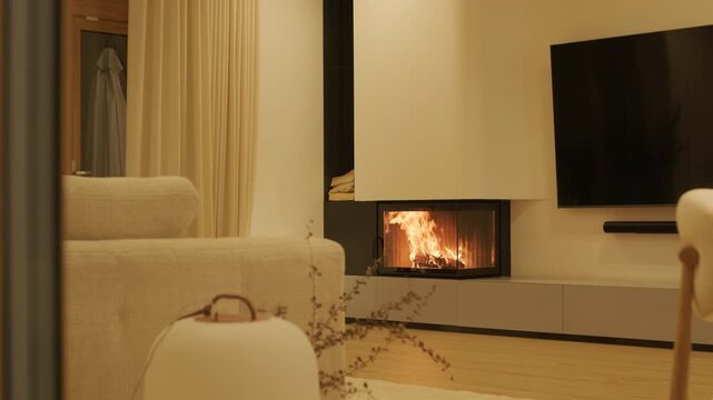 Cozy modern living room with a burning corner fireplace   
