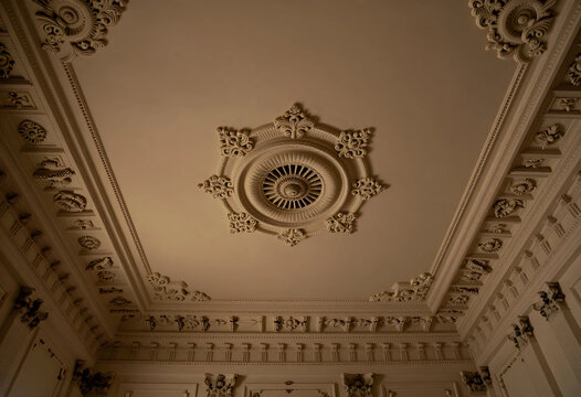 Architecture and interior design, ornate ceiling molding with classical plasterwork and decorative rosettes in a historic building or luxury residence