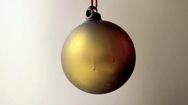 Green Glass Christmas Bauble With a Warm Golden Sheen
