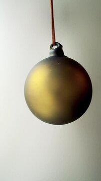 Hand Blown Glass Bauble in Green and Gold Vertical Video