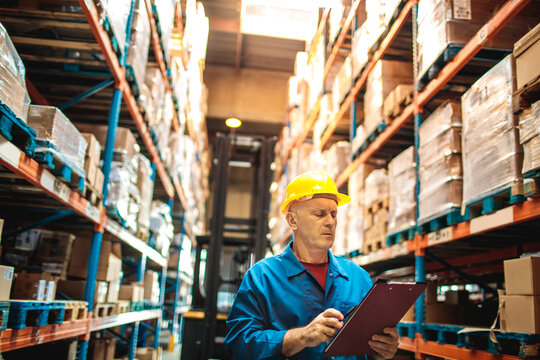 Warehouse worker checks inventory with clipboard
