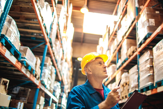 Warehouse worker checking inventory with clipboard