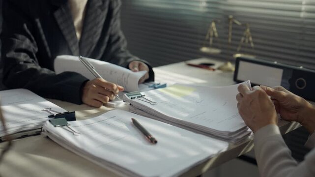 Lawyers Reviewing Contract Documents During Legal Consultation in Law Office