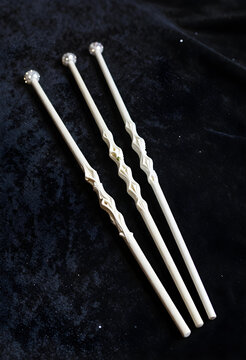 Magic wands with crystal tips, fantasy and wizardry concept, handmade wooden props for cosplay and roleplay games on a dark velvet background