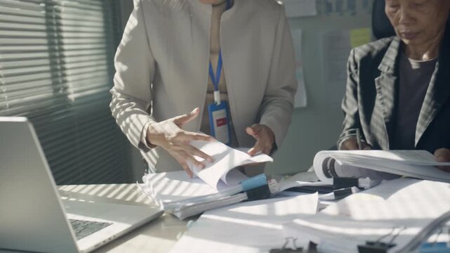 Business Professionals Reviewing Documents and Managing Heavy Office Workload