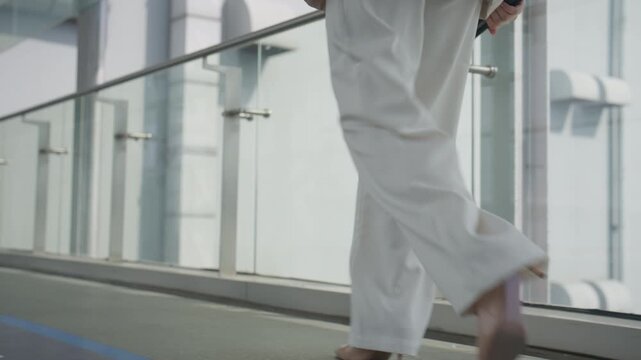 Confident Female Professional Walking to Work in Modern Business Building