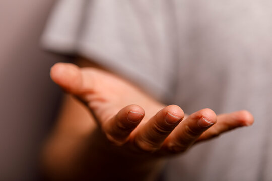 The human hand is open and extended, symbolizing offering, receiving, or showing.