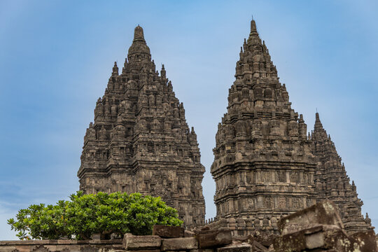 Prambanan Temple in Central Java, Indonesia. A vast 9th-century Hindu temple complex with intricate stone spires, sculptures, and ancient ruins under a cloudy sky.