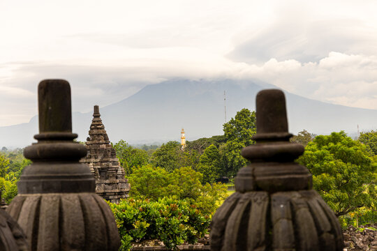 Prambanan Temple in Central Java, Indonesia. A vast 9th-century Hindu temple complex with intricate stone spires, sculptures, and ancient ruins under a cloudy sky.