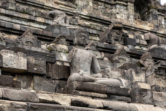 Ancient stone stupas of Borobudur, a UNESCO World Heritage Buddhist monument in Central Java, Indonesia, under an overcast sky.