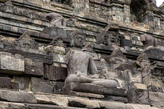 Ancient stone stupas of Borobudur, a UNESCO World Heritage Buddhist monument in Central Java, Indonesia, under an overcast sky.