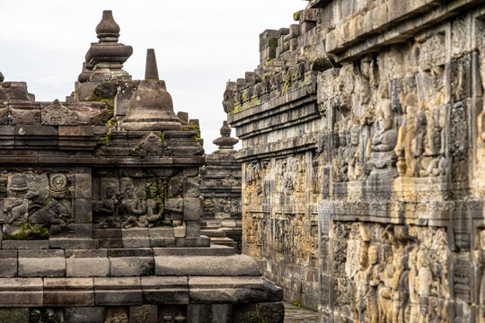 Ancient stone stupas of Borobudur, a UNESCO World Heritage Buddhist monument in Central Java, Indonesia, under an overcast sky.
