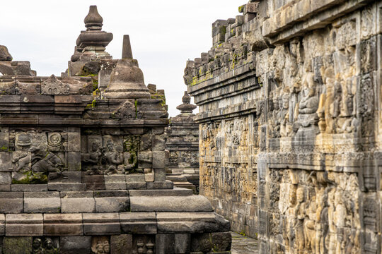 Ancient stone stupas of Borobudur, a UNESCO World Heritage Buddhist monument in Central Java, Indonesia, under an overcast sky.