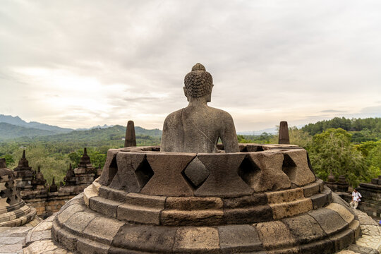 Ancient stone stupas of Borobudur, a UNESCO World Heritage Buddhist monument in Central Java, Indonesia, under an overcast sky.