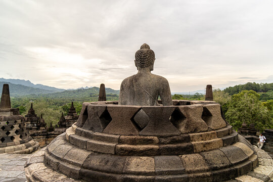 Ancient stone stupas of Borobudur, a UNESCO World Heritage Buddhist monument in Central Java, Indonesia, under an overcast sky.
