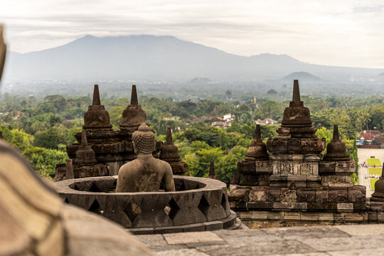 Ancient stone stupas of Borobudur, a UNESCO World Heritage Buddhist monument in Central Java, Indonesia, under an overcast sky.