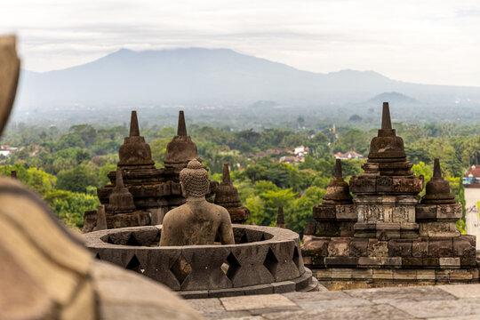 Ancient stone stupas of Borobudur, a UNESCO World Heritage Buddhist monument in Central Java, Indonesia, under an overcast sky.