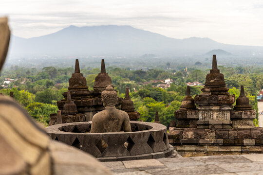 Ancient stone stupas of Borobudur, a UNESCO World Heritage Buddhist monument in Central Java, Indonesia, under an overcast sky.