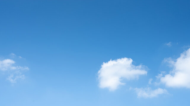 The sky is a vibrant, cloudless blue, while the sun shines brightly, making it appear even more radiant.
