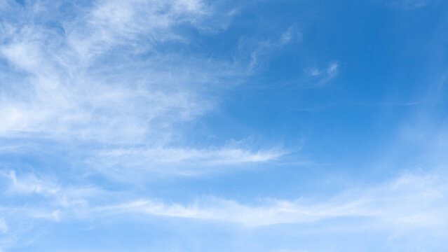 The sky is a vibrant, cloudless blue, while the sun shines brightly, making it appear even more radiant.