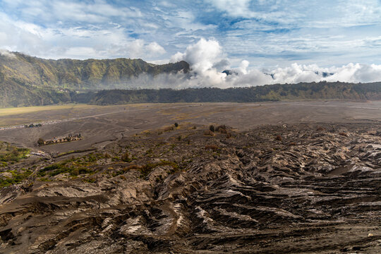 Active Mount Bromo volcano crater with sulfur smoke and volcanic sand sea, Tengger Semeru National Park, East Java, Indonesia.