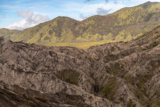 Active Mount Bromo volcano crater with sulfur smoke and volcanic sand sea, Tengger Semeru National Park, East Java, Indonesia.