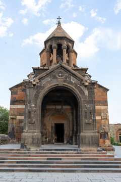 Khor Virap church chapel entrance with a gabled arched portico with red and black tuff stone bands and an octagonal bell tower and a wide stone staircase, Khor Virap, Armenia