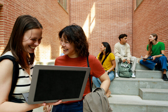 Students Work Together on Laptops