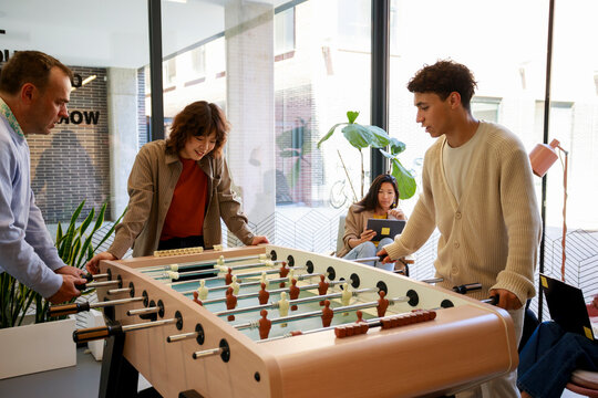 Group Plays Foosball in Office