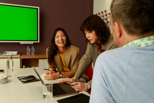 Group Works Together in Meeting Room