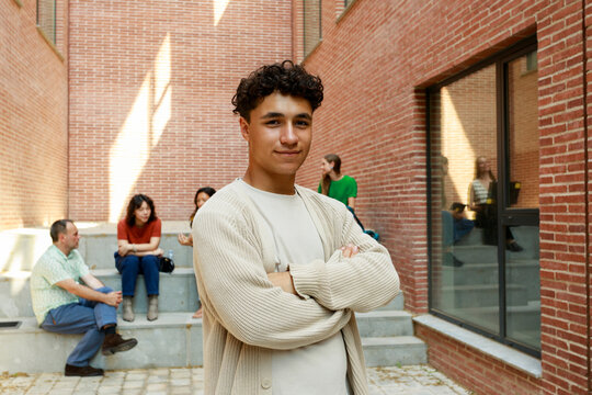 Young Man Poses With Confidence in a Simple Brick Courtyard