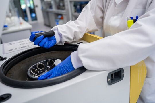Scientist Operating a Centrifuge in a Laboratory