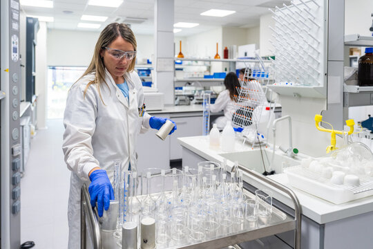 Scientist Works in Laboratory With Glassware and Equipment