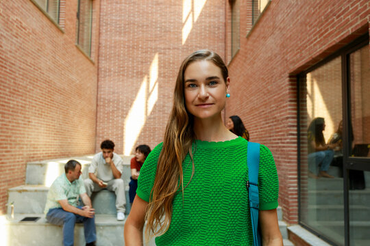 Young Woman Stands in Modern Building