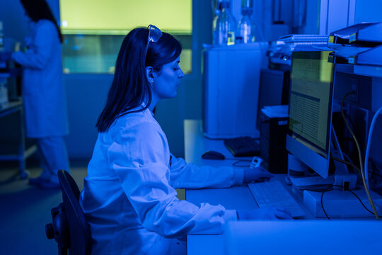 Scientist Working at a Computer in a Lab During Evening Hours