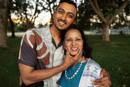 Candid son and mother embracing with real happy emotion