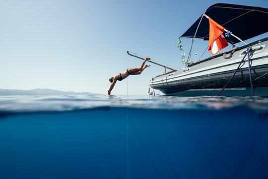 female freediver entering the sea from a diving boat