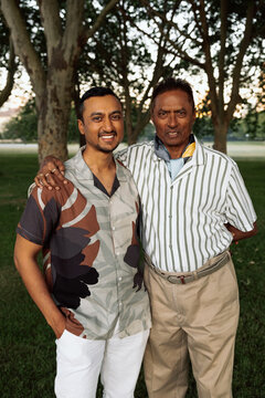 Father and son portrait in park sharing a nice smiling portrait